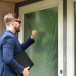 Man Who Is a Process Server Standing At The Entrance Of a House Knocking The Door to serve papers
