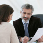 Attorney meeting client in office to discuss witness coaching