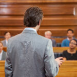 male lawyer standing in front of jury during opening statement