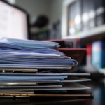 stack of medical records sitting on a desk after record retrieval in lawyers office
