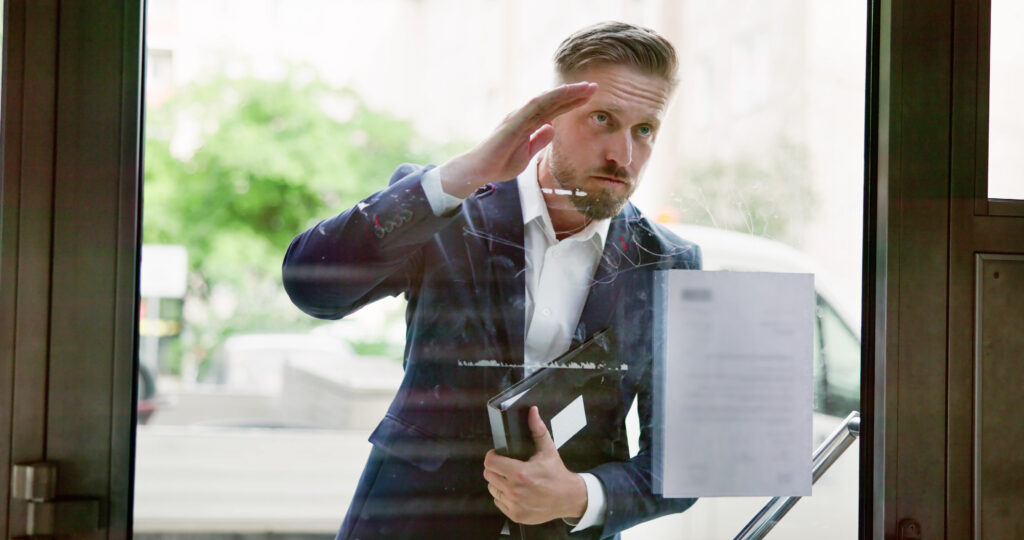 process server looking into the window attempting to serve documents