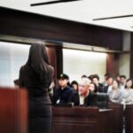 lawyer talking to room of jurors during a mock trial