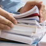 court reporter sorting through a stack of paperwork