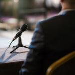 credible witness giving statement on the stand with a microphone in front of him