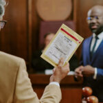 Man holding evidence bag while standing in courtroom, showing what is an exhibit in court