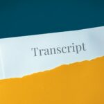 Deposition transcript in brown envelope. Hand opens envelope and takes out documents.