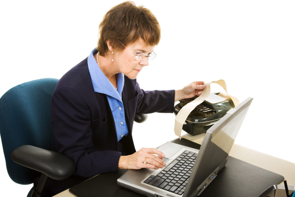 Court reporter typing up the court transcript on her laptop computer. Isolated on white.